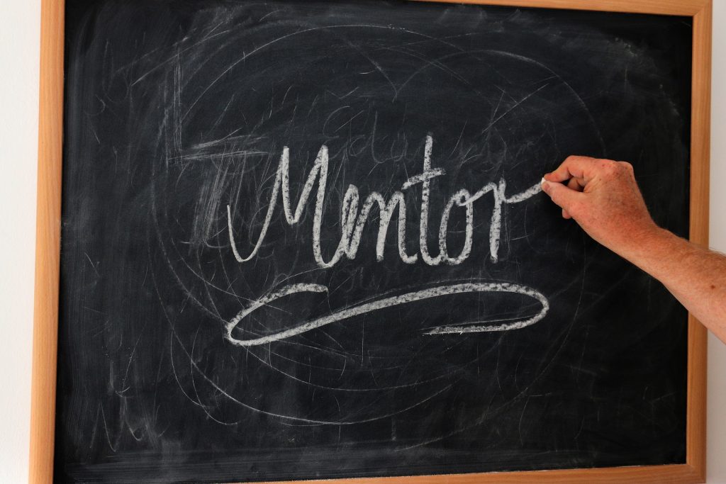 writing on chalkboard of word mentor