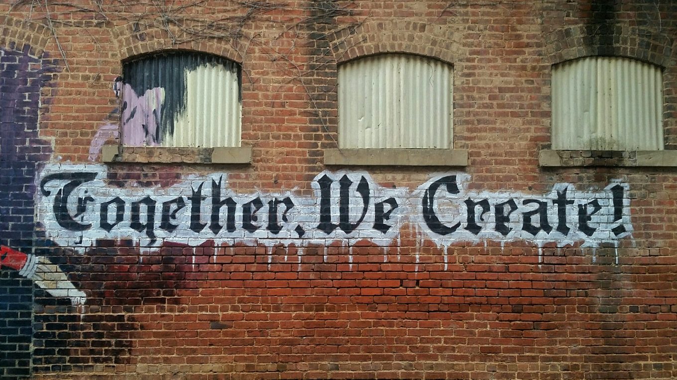 image of brick wall with graffiti letters